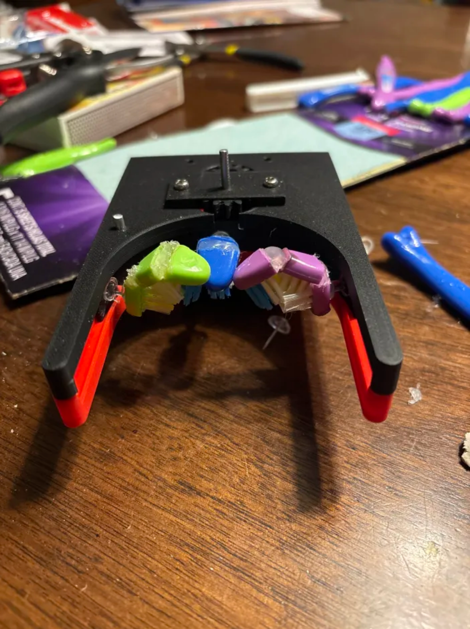 This is a picture of our prototype which was 3D printed and uses a motor to move brush heads along the case.