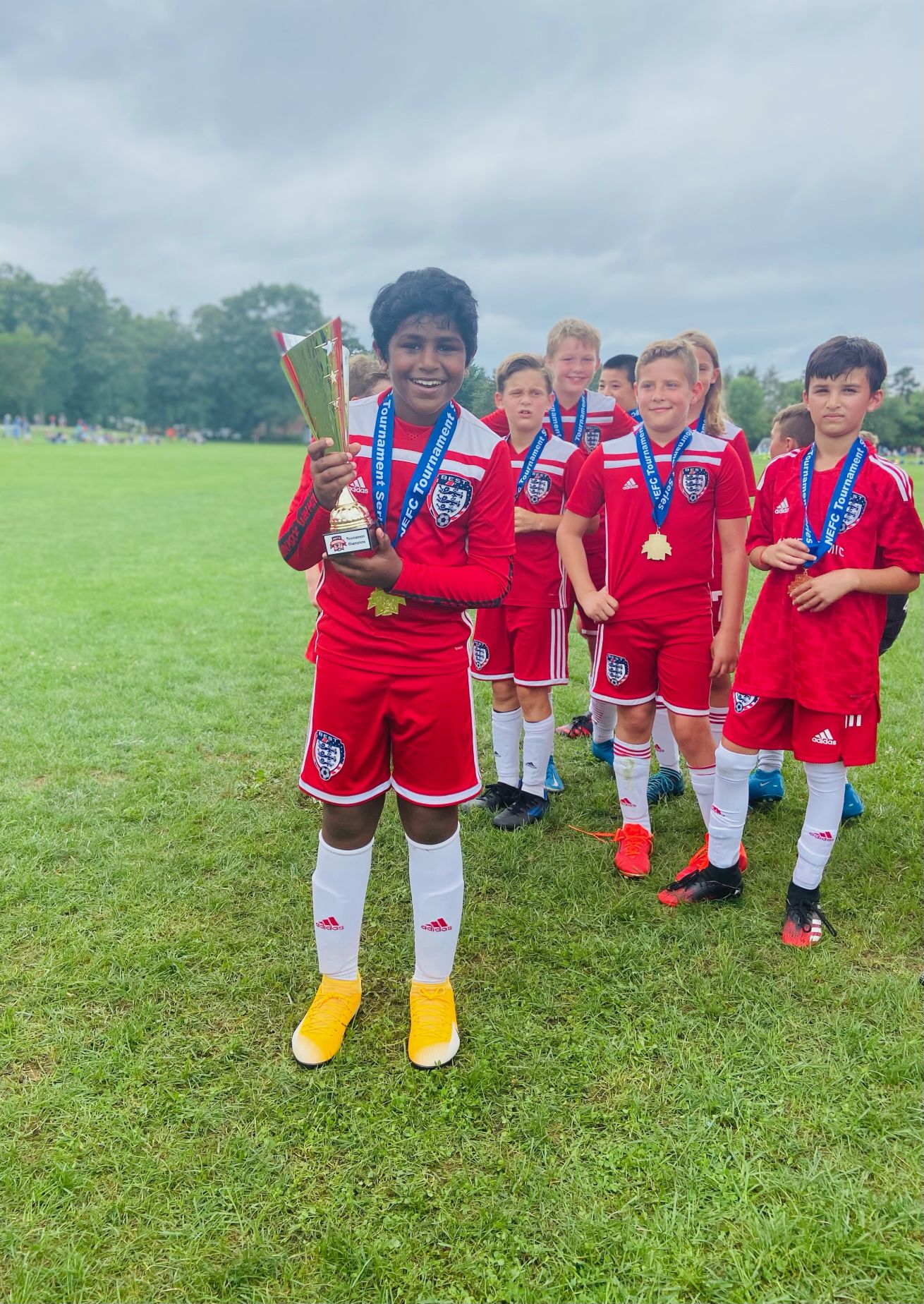This is a photo of me and my teammates winning a soccer tournament when I was younger.