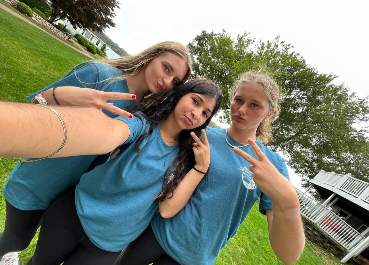  Three girls holding up finger peace signs