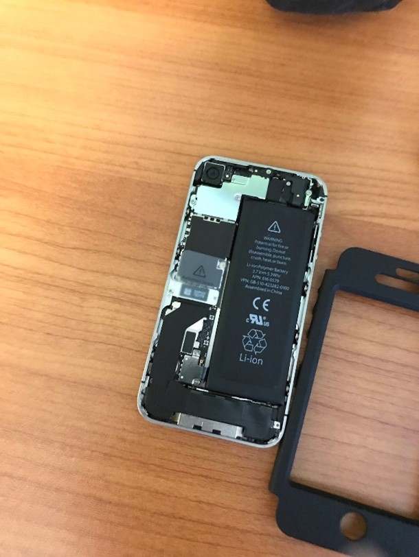 An iPhone 4 with its back taken off so that the internal components are visible.