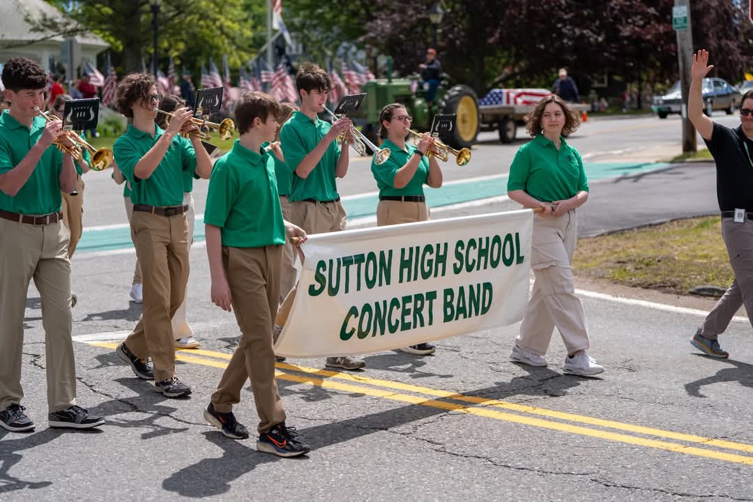 A photo of Sutton High School marching in the
	Memorial Day Parade