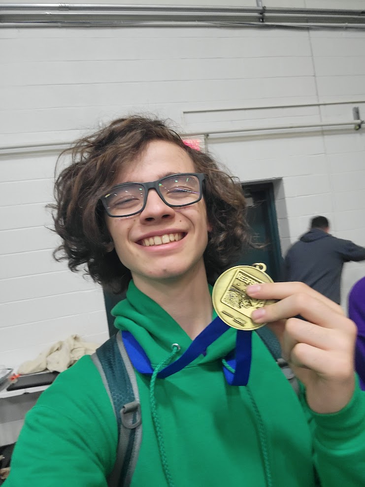 A photo of me holding my medal after winning UVM