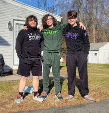 My cousin, older brother, and I wearing matching throwing
		 shirts for Track