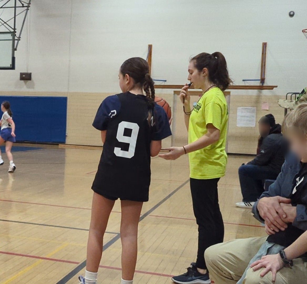 picture of me holding a basketball while refing a game. 