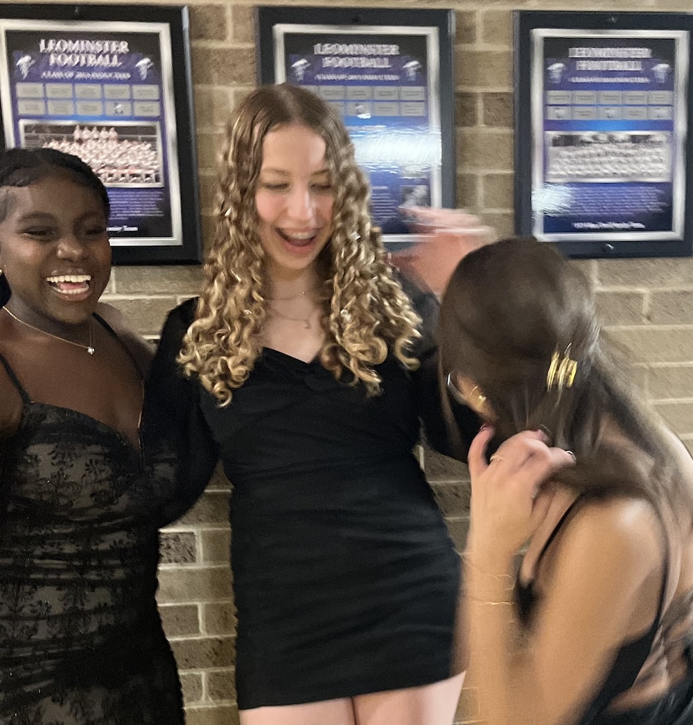 =Girl in black dress, hugging person on left