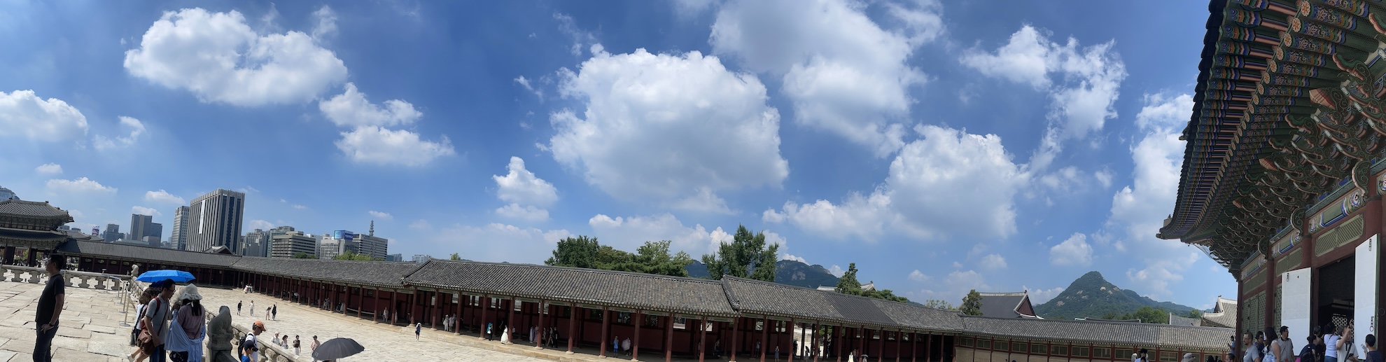 A panorama of the view from the Seoul palace grounds, spanning from the city to mountains.