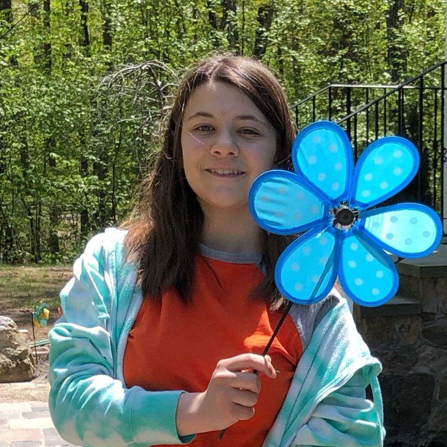 Lydia posing with a colorful pinwheel