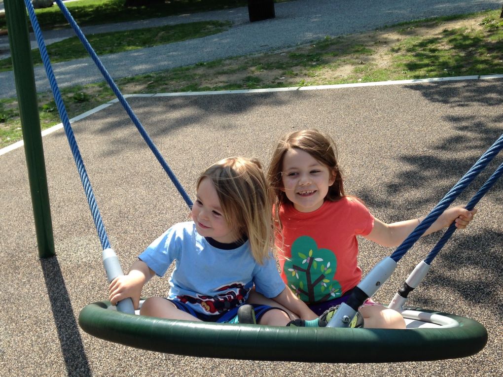 Lydia and little brother on a swing