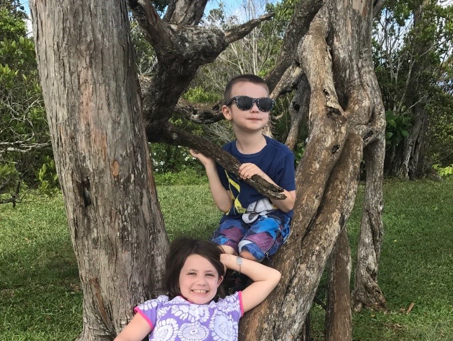 Lydia and little brother in a tree