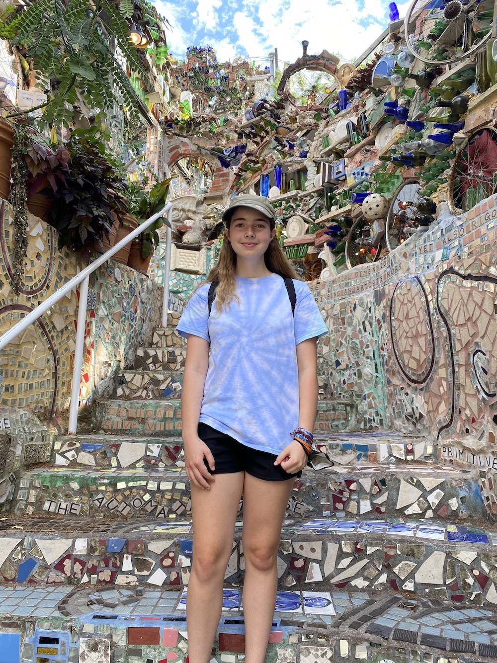 Full body picture of Lindsey Paradise standing at the Magic Gardens art exhibit in Philadelphia, PA