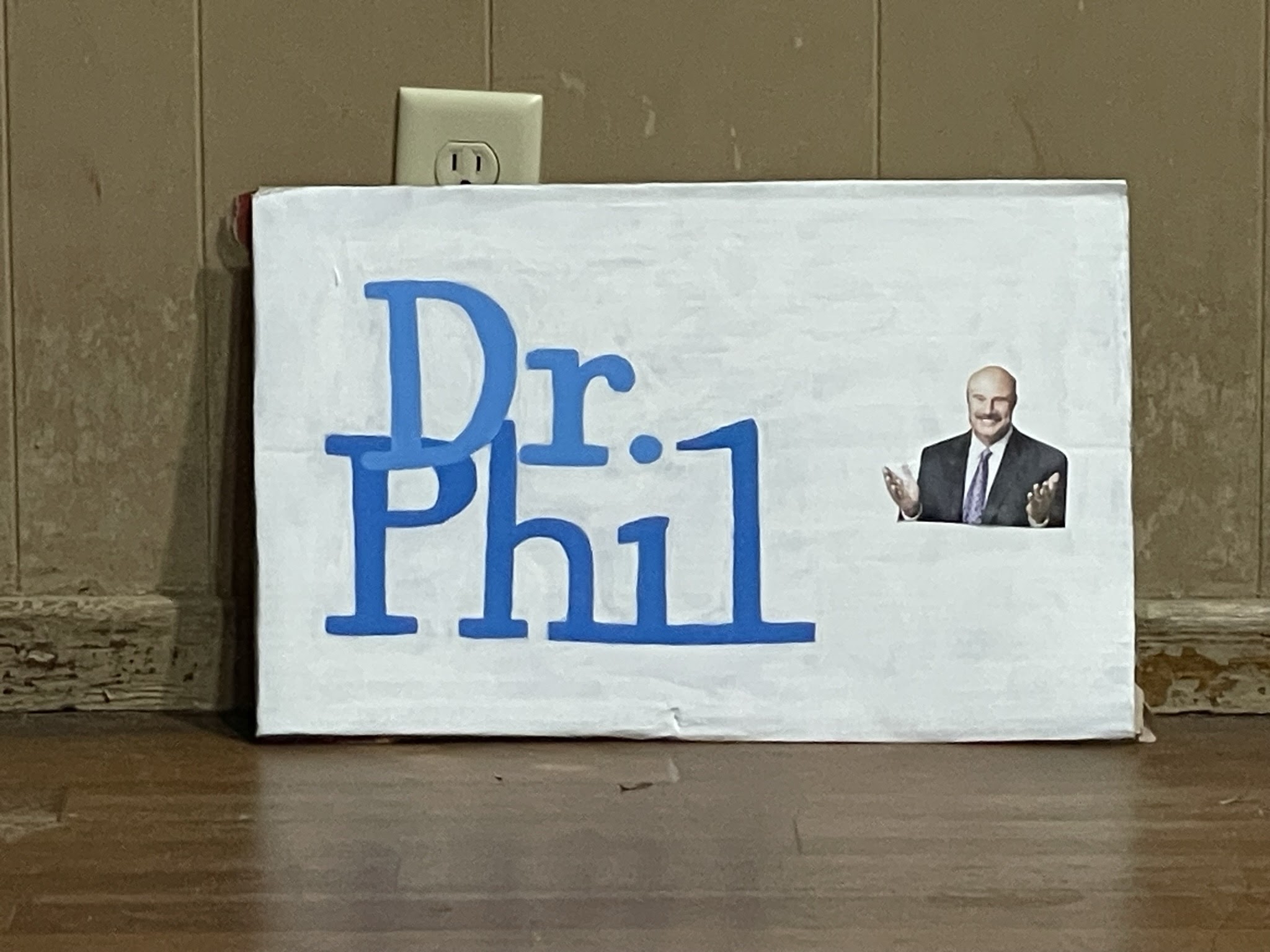 Painted Dr. Phil logo on white background.