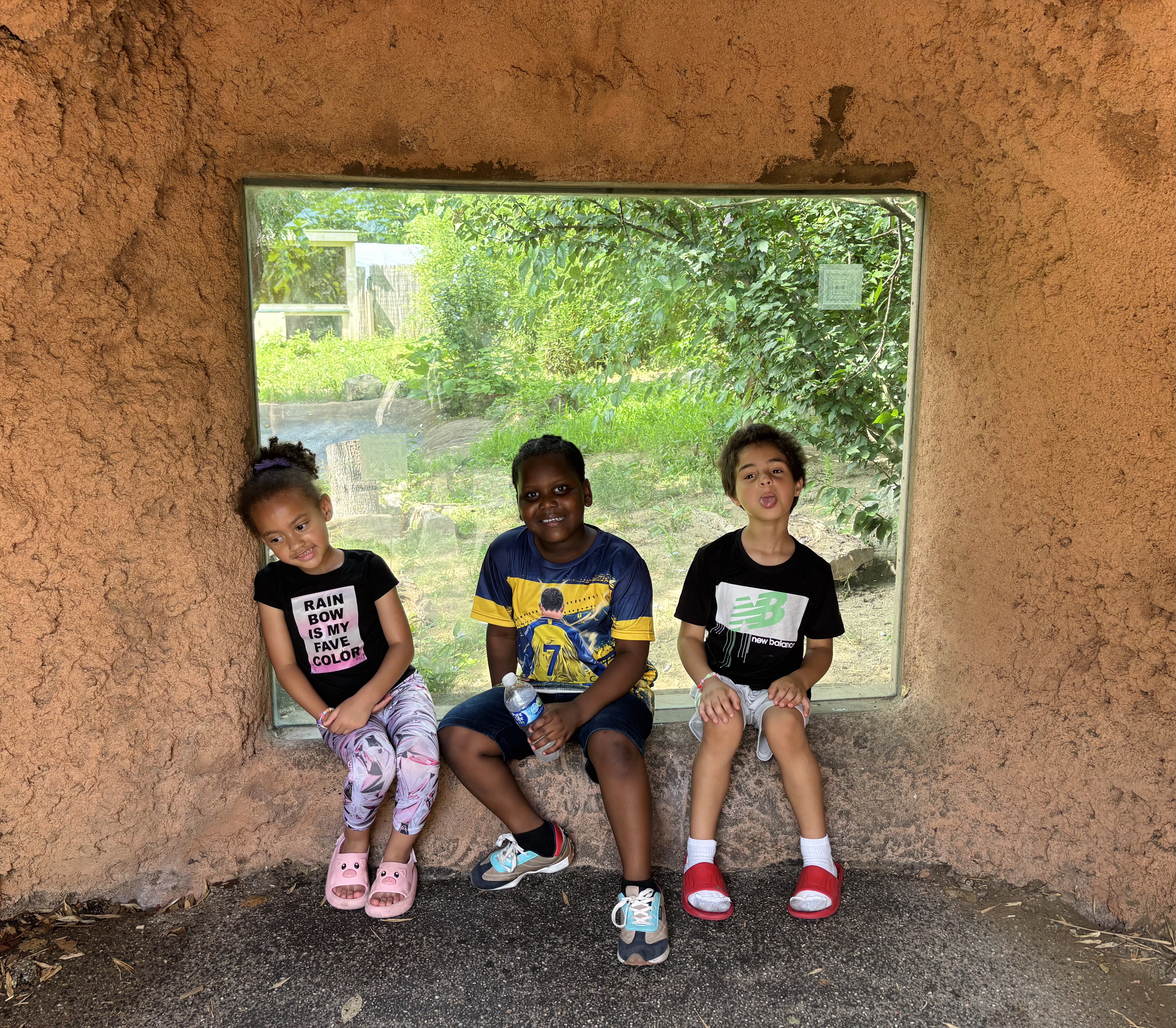 Kids posing infront of animal window