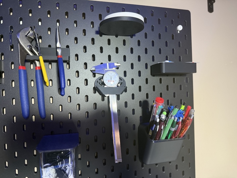 Picture of 3D printed attachments on pegboard