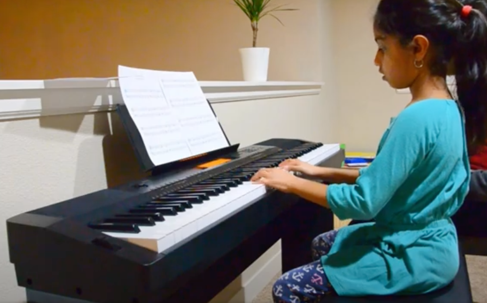 girl playing the piano