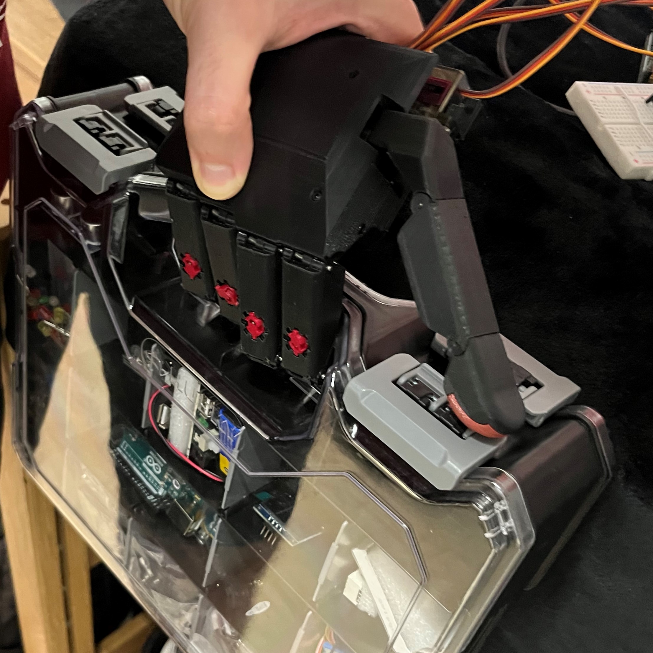 The hand is holding a light bin with closed fingers.