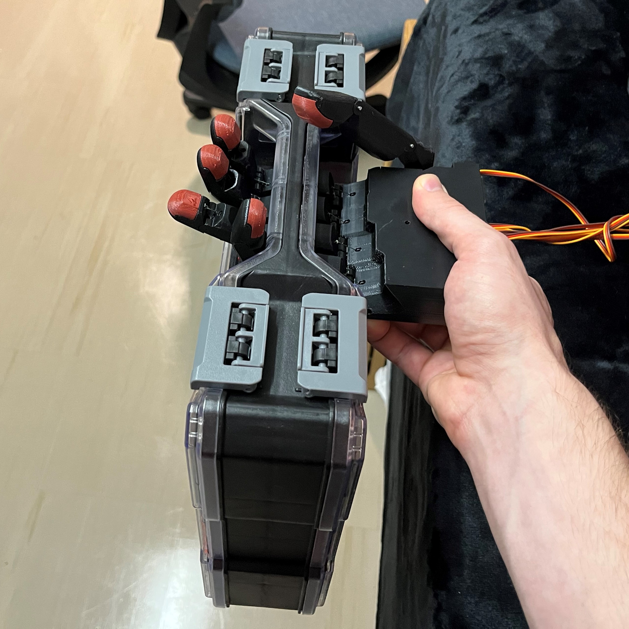 The hand is holding a light bin with open fingers.